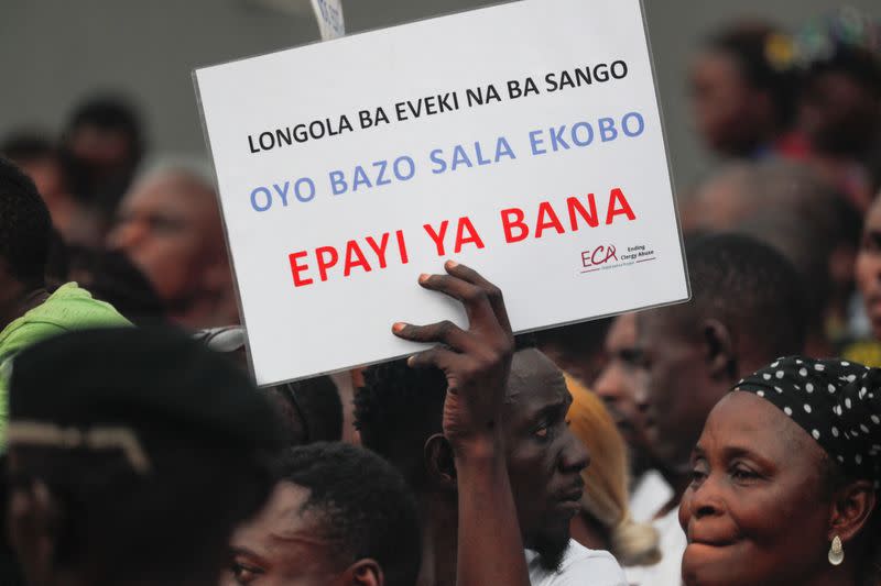 Members of Ending Clergy Abuse (ECA) hold a protest in front of the Cathedral Notre Dame De Lingwala in Kinshasa