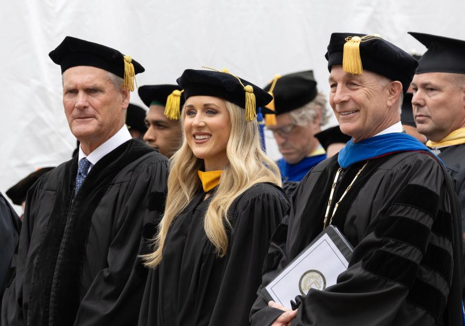 From left to right, E.L. “Nick” Nicolay III, who received an honorary degree Doctor of Humane Letters; Riley Gaines, the keynote speaker for Adrian College's 2024 spring commencement; and Adrian College President Jeffrey Docking are pictured Sunday during the college's commencement exercises.