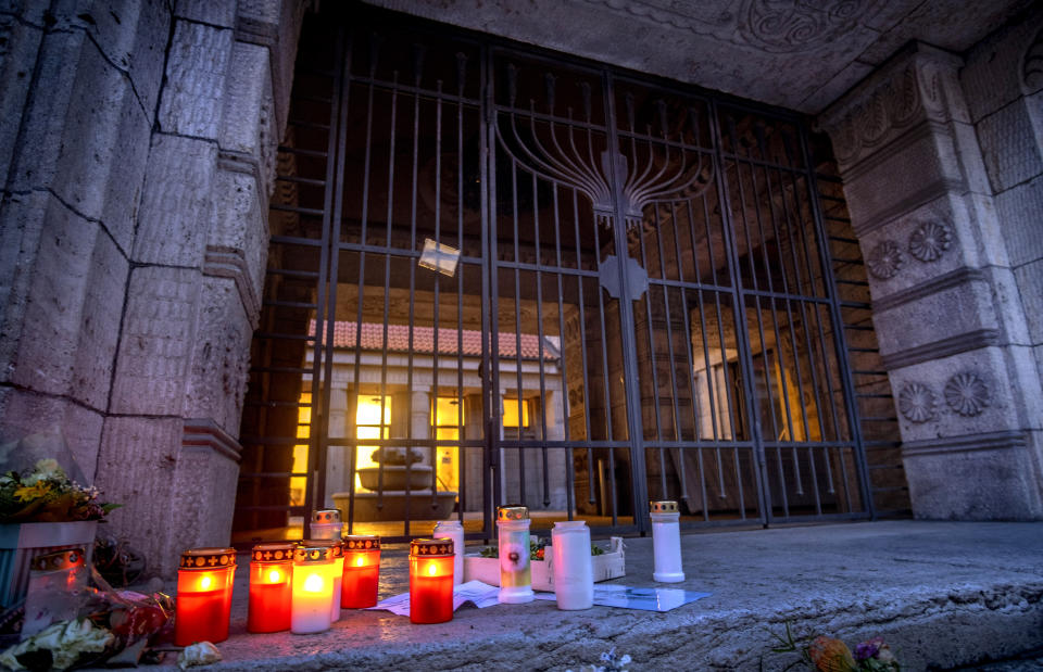 Candles are lit in front of the synagogue in Frankfurt, Germany, early Wednesday, Nov. 8, 2023. Antisemitism is spiking across Europe after Hamas' Oct. 7 massacre and Israel's bombardment of Gaza, worrying Jews from London to Geneva and Berlin. (AP Photo/Michael Probst)