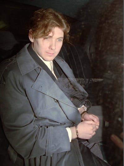 Paul Bernardo sits in the back of a police cruiser in April 1994 as he leaves a hearing in St. Catharines, Ont. THE CANADIAN PRESS/Frank Gunn