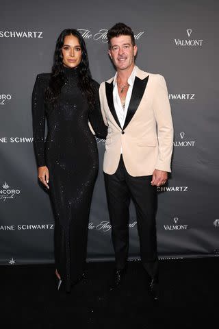 <p>Jamie McCarthy/Getty</p> April Love Geary and Robin Thicke attend the Angel Ball in New York City in October 2023