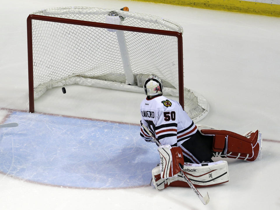 Chicago Blackhawks goalie Corey Crawford watches as a puck shot by St. Louis Blues' Alex Pietrangelo bounces off the back of the net for a goal during the third period in Game 5 of a first-round NHL hockey playoff series Friday, April 25, 2014, in St. Louis. (AP Photo/Jeff Roberson)