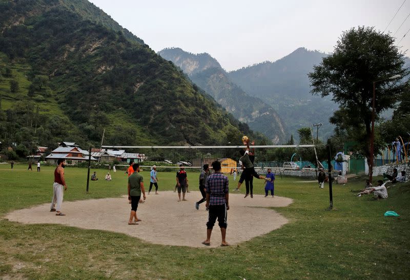 Men play volleyball in a playground near the Line of Control between India and Pakistan in Teetwal