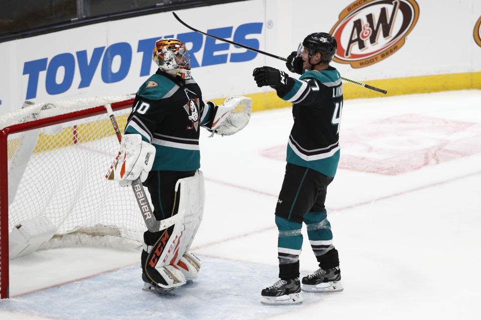 Anaheim Ducks goaltender Kevin Boyle, left, and teammate Hampus Lindholm celebrate the Ducks' 1-0 win against the Vancouver Canucks in an NHL hockey game Wednesday, Feb. 13, 2019, in Anaheim, Calif. (AP Photo/Jae C. Hong)