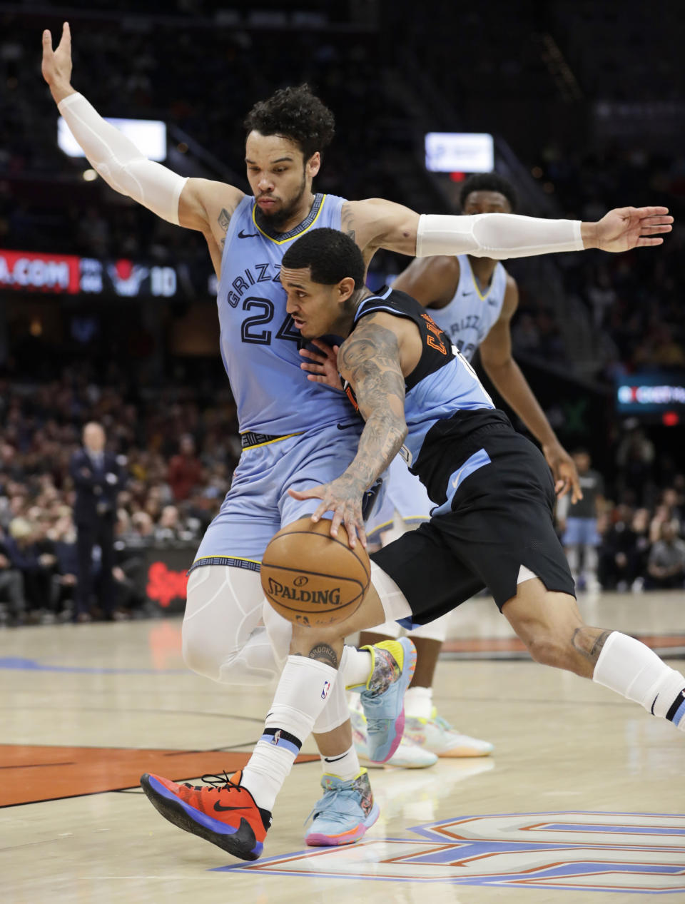 Cleveland Cavaliers' Jordan Clarkson, front right, drives past Memphis Grizzlies' Dillon Brooks (24) in the second half of an NBA basketball game, Friday, Dec. 20, 2019, in Cleveland. (AP Photo/Tony Dejak)