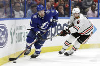 Tampa Bay Lightning center Tyler Johnson (9) moves around a stick check by Chicago Blackhawks defenseman Olli Maatta (6) during the second period of an NHL hockey game Thursday, Feb. 27, 2020, in Tampa, Fla. (AP Photo/Chris O'Meara)