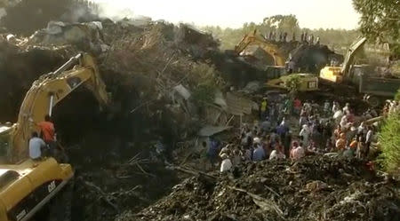 Excavators work after a landslide at a garbage dump on the outskirts of Addis Ababa, Ethiopia in this still image taken from a video from March 12, 2017. REUTERS/Reuters TV