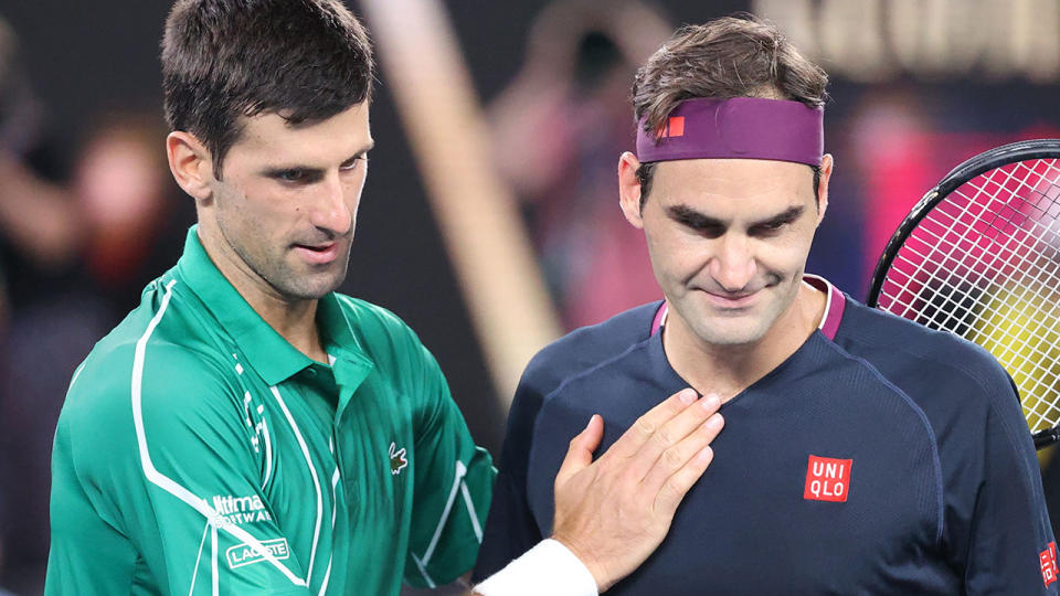 Novak Djokovic is pictured with Roger Federer after their match at the 2020 Australian Open.