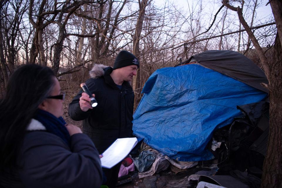 Shaun Hutchinson, right, and Yahaira Padilla, of Bergen County Veterans Services, talk with a homeless man who was sleeping in a wooded area in southwestern Bergen County on Wednesday Jan. 26, 2022. Bergen County Health and Human Services personnel travel throughout the county to find and document homeless individuals during the Point-in-Time homeless count. 