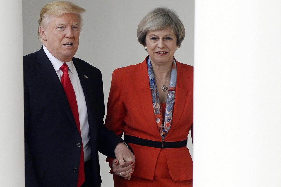 Hand of friendship: The US and UK leaders hold hands briefly. (EPA)