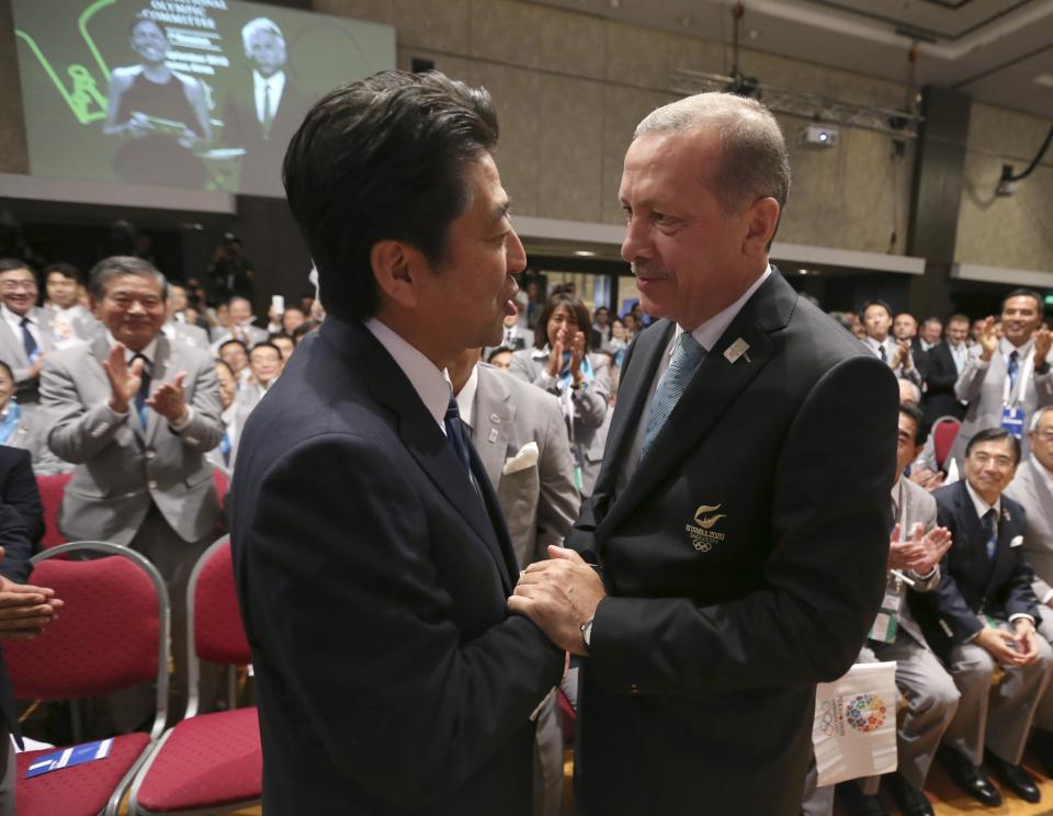 Turkish Prime Minister Tayyip Erdogan congratulates Prime Minister Shinzo Abe of Japan after Jacques Rogge President of the International Olympic Committee announced Tokyo as the city to host the 2020 Summer Olympic Game during a ceremony in Buenos Aires