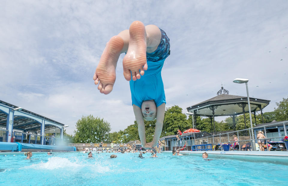 A child enjoys the hot weather at Hathersage open air swimming pool at Hope Valley, near Sheffield. Temperatures are predicted to hit 31C across central England on Sunday ahead of record-breaking highs next week. Picture date: Sunday July 17, 2022.