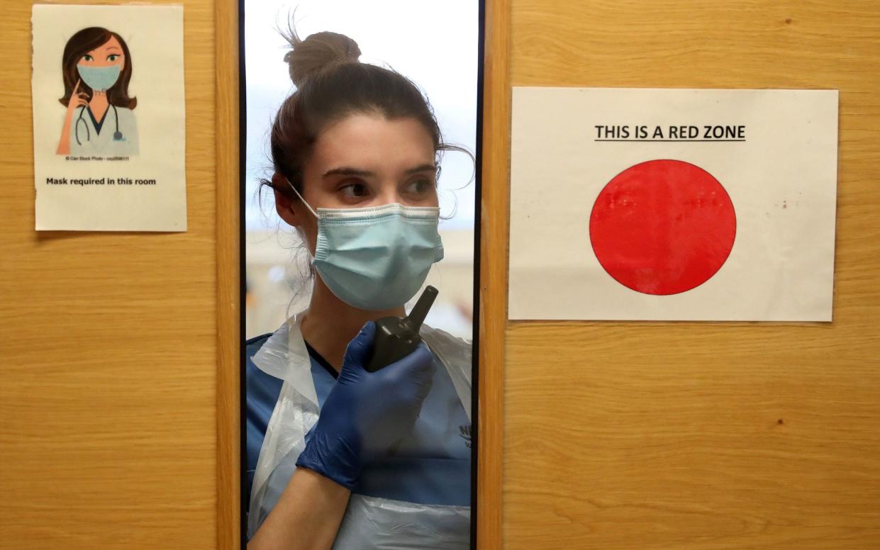 A nurse communicates using walkie talkies from a Covid area to a ward A31 at a hospital in Stirlingshire - Ben Birchall/PA