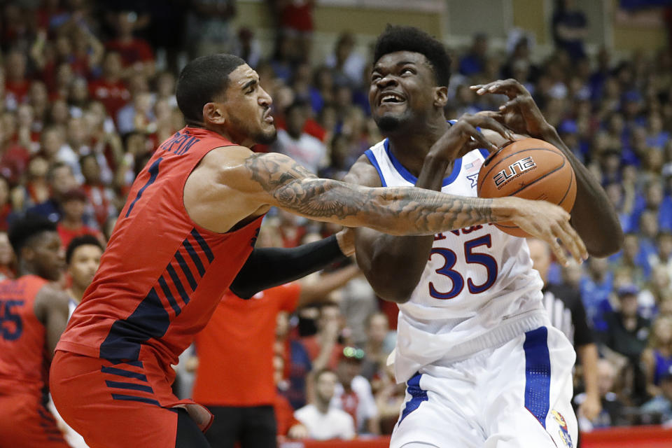 FILE - In this Nov. 27, 2019, file photo, Dayton forward Obi Toppin (1) knocks the ball away from Kansas center Udoka Azubuike (35) during the first half of an NCAA college basketball game in Lahaina, Hawaii. Kansas and Dayton were headed toward earning No. 1 seeds in the NCAA tournament, so any meeting would have to be in the Final Four or national championship game. What a rematch it would be. The Jayhawks and Flyers played a high-level game at the Maui Invitational, won 90-84 in overtime by Kansas. (AP Photo/Marco Garcia, File)