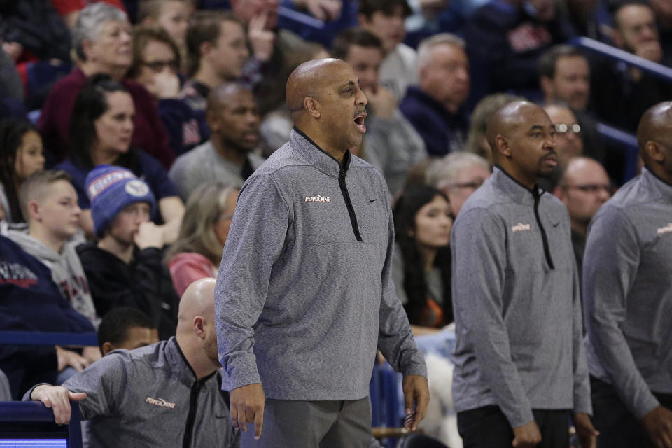 Pepperdine head coach Lorenzo Romar, center, directs his team during the first half of an NCAA college basketball game against Gonzaga, Saturday, Dec. 31, 2022, in Spokane, Wash. (AP Photo/Young Kwak)