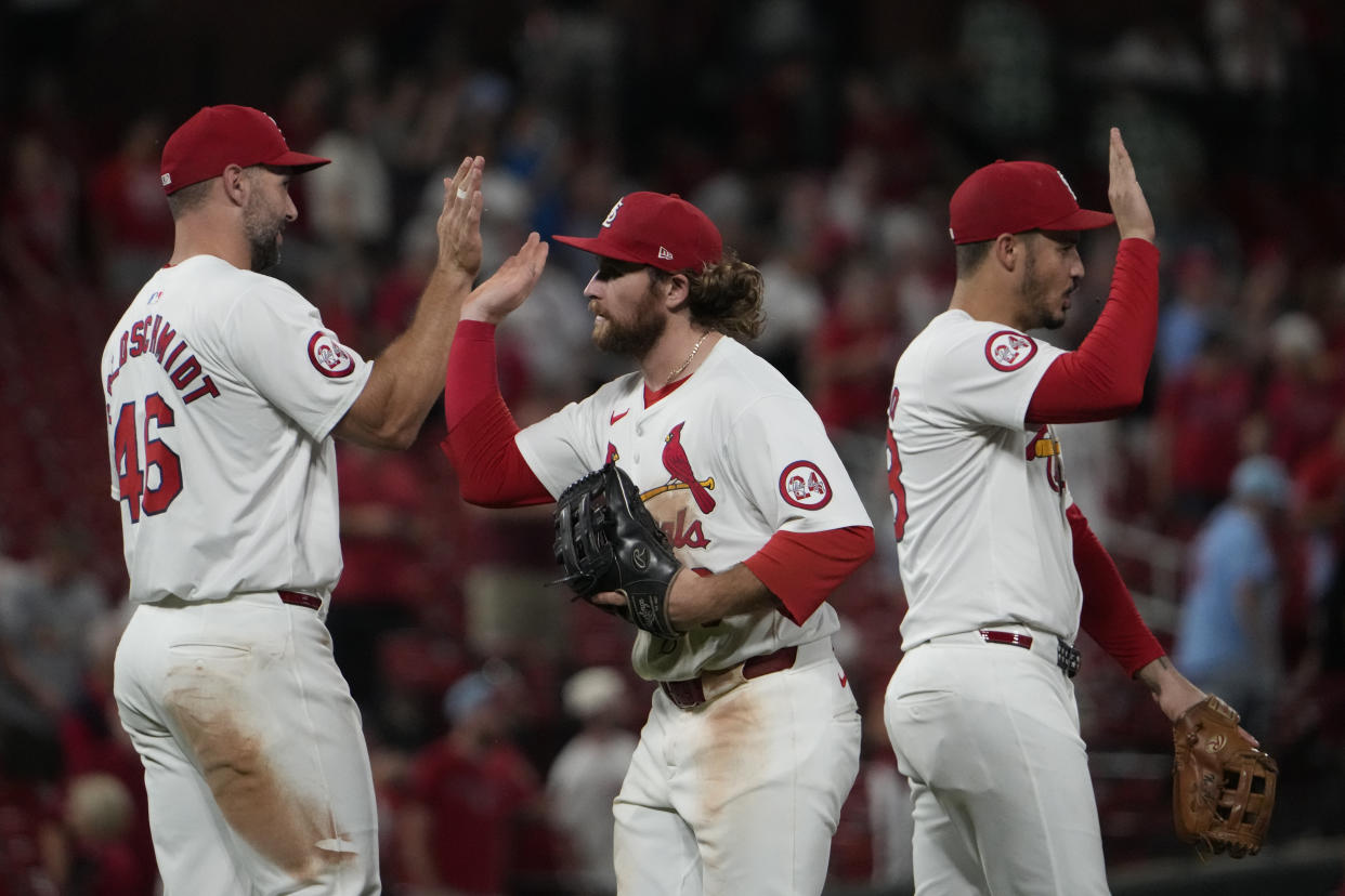 St. Louis Cardinals' Paul Goldschmidt, left, Brendan Donovan, center, and Nolan Arenado, right, celebrate a 3-1 victory following a baseball game against the Pittsburgh Pirates Tuesday, Sept. 17, 2024, in St. Louis. (AP Photo/Jeff Roberson)