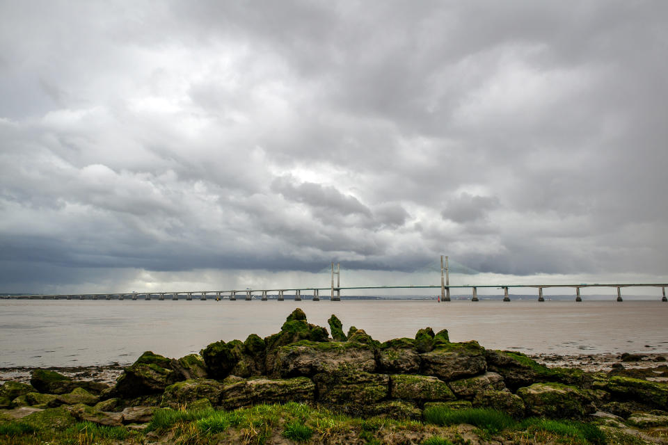 Storm clouds brood over the Prince of Wales Bridge in the Severn Estuary, as Britain is set to be hit with thunderstorms and heavy rain this week. (Photo by Ben Birchall/PA Images via Getty Images)