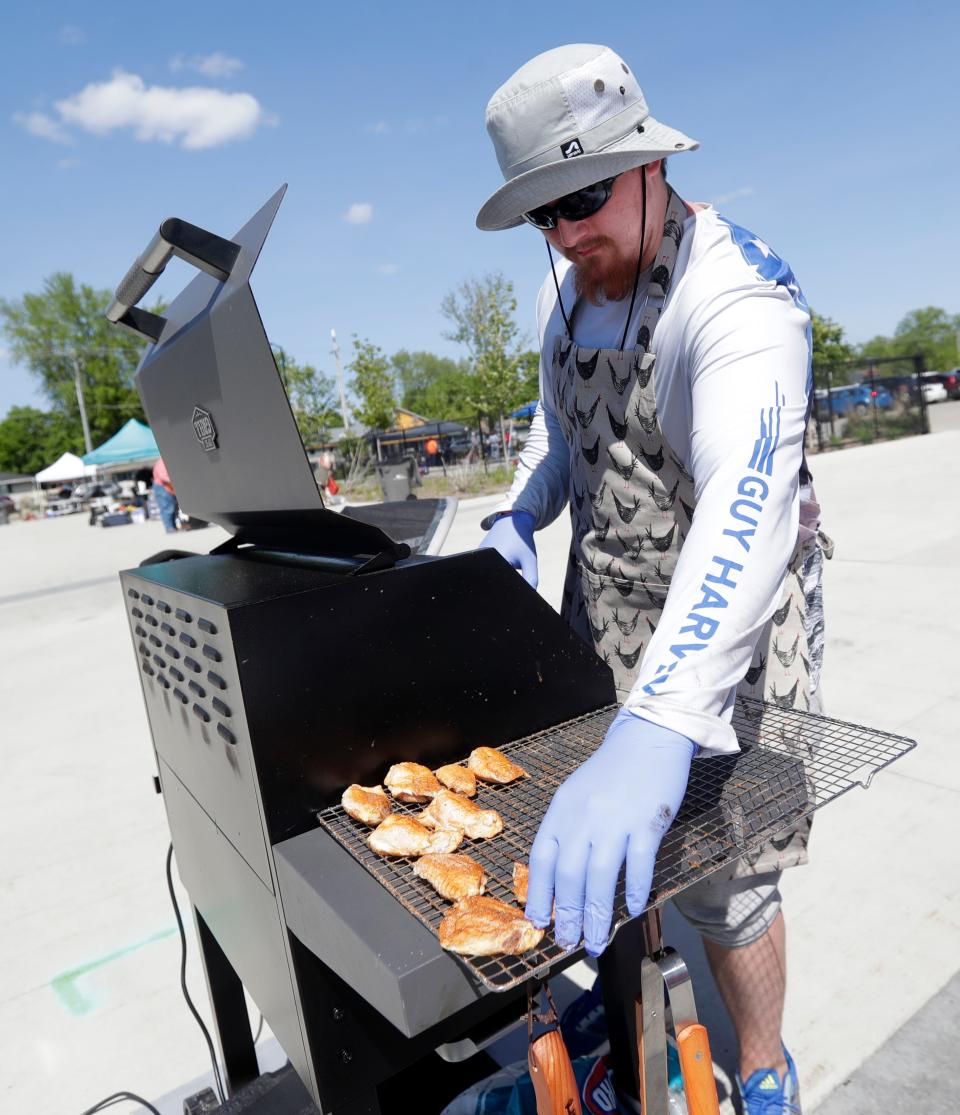 Devin Hildebrand of Green Bay participates in the Meat Smoking Club of Wisconsin's cooking competition at last year's MeatFest. The club will be doing a rib cook-off this year.