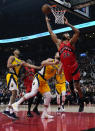 Toronto Raptors center Khem Birch (24) drives past Indiana Pacers forward Domantas Sabonis (11) during the first half of an NBA basketball game, Wednesday, Oct. 27, 2021 in Toronto. (Nathan Denette/The Canadian Press via AP)