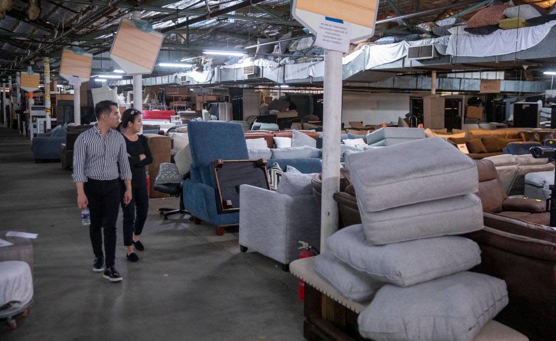 Customers browse through the furniture at The 16th Avenue Warehouse in Conway. The warehouse store sells discount furniture, appliances, and home goods including overruns, scratch and dent returns items and second hand hotel furniture. February 23, 2023.