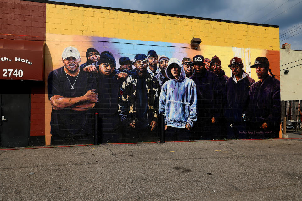 A mural painted on the side of a bar building shows a dozen rappers surrounding Detroit's Eminem.