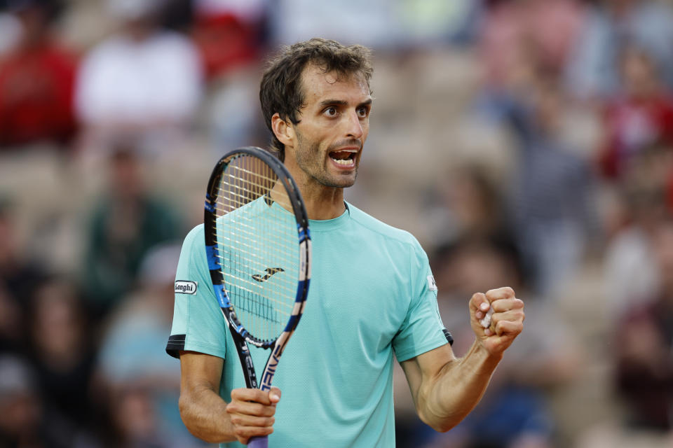 Spain's Albert Ramos-Vinolas clenches his fist after scoring a point against Spain's Carlos Alcaraz during their second round match at the French Open tennis tournament in Roland Garros stadium in Paris, France, Wednesday, May 25, 2022. (AP Photo/Jean-Francois Badias)