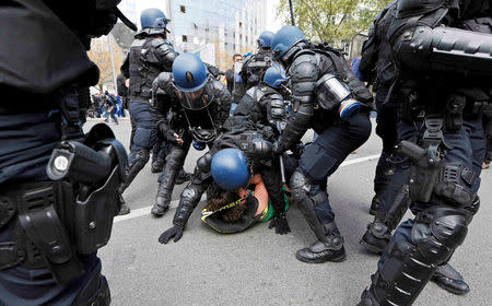 French riot police officers detain a protestor during a demonstration against the French labor law proposal in Lyon, France, as part of a nationwide labor reform protests and strikes, April 28, 2016. REUTERS/Robert Pratta