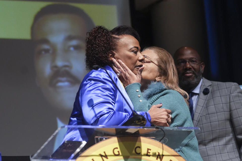 Bernice King daughter of civil-right leader Martin Luther King Jr., left, gets a kiss from Alveda King a she speaks about her brother Dexter Scott King during a news conference Tuesday, Jan. 23, 2024, in Atlanta. Dexter died Monday, Jan. 22, 2024 at his California home after battling prostate cancer. (AP Photo/John Bazemore)