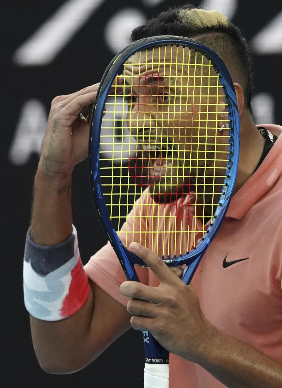 Australia's Nick Kyrgios reacts to a missed shot against Spain's Rafael Nadal during their fourth round singles match at the Australian Open tennis championship in Melbourne, Australia, Monday, Jan. 27, 2020. (AP Photo/Lee Jin-man)