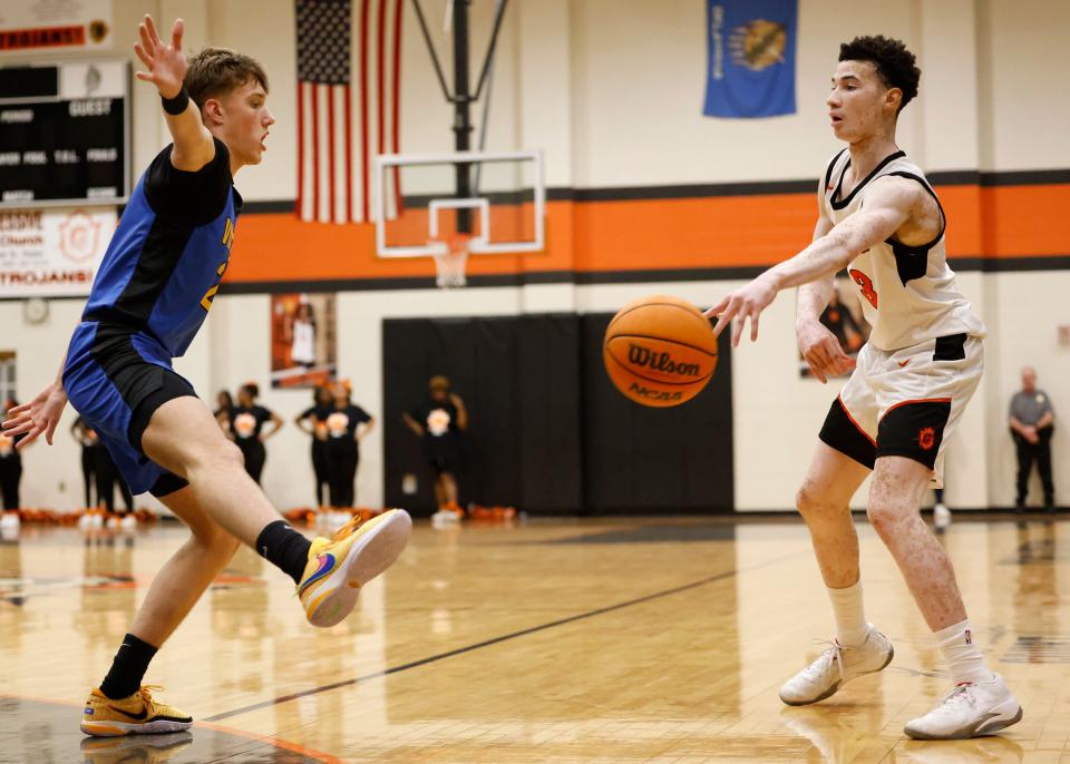 Douglass' Jaden Williams, right, passes the ball away from Victory Christian's Jordan Brown during a high school basketball game Friday, Feb. 2, 2024, at Douglass High School.