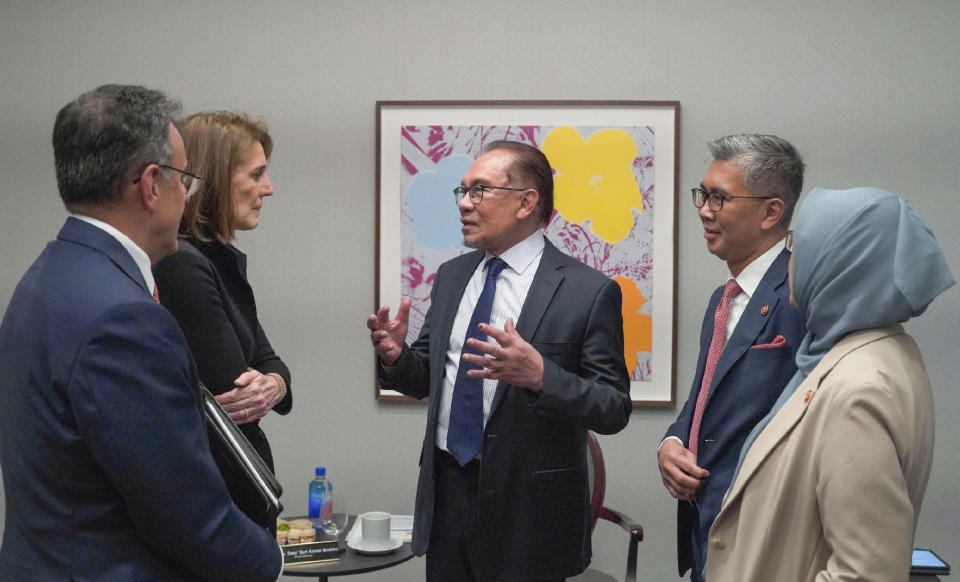 In this photo provided by Malaysia’s Ministry of Investment, Trade and Industry, Malaysian Prime Minister Anwar Ibrahim, center, talks with Alphabet Inc. Chief Financial Officer Ruth Porat in New York, NY., on Sept. 2023. Google pledged Thursday, May 30, 2024, to commit $2 billion in Malaysia, including building its first data center and Google Cloud region in its biggest planned investment in the Southeast Asian country.(Malaysia’s Ministry of Investment, Trade and Industry via AP)