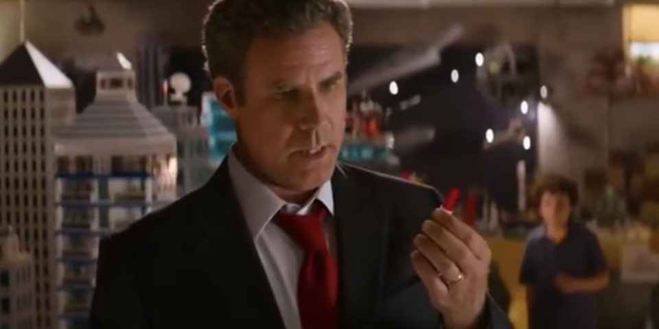 Will Ferrell as the dad, looking at a lego