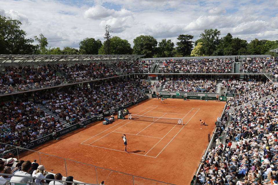 Spain's Carlos Alcaraz, front, serves the ball to Spain's Albert Ramos-Vinolas during their second round match of the French Open tennis tournament on the Simonne Mathieu court at the Roland Garros stadium Wednesday, May 25, 2022 in Paris. (AP Photo/Jean-Francois Badias)