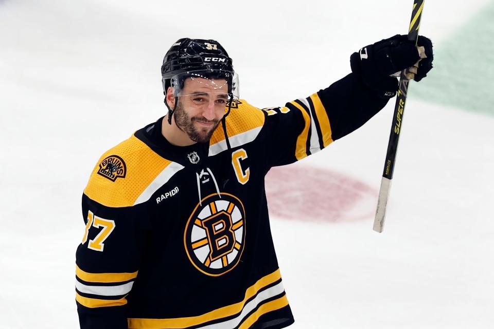 The Bruins' Patrice Bergeron raises his stick to acknowledge the fans after losing to the Florida Panthers in overtime in Game 7 of their first-round Stanley Cup playoff series on Sunday.