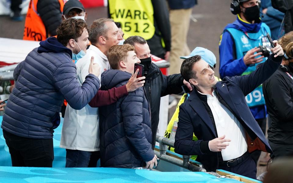 Gary Neville (right) takes a selfie with fans ahead of the UEFA Euro 2020 Group D match - Mike Egerton/PA