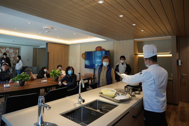 Elderly people attend a cooking class, at a nursing home of Lendlease's Ardor Gardens in Shanghai