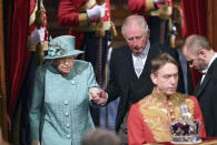 Britain's Queen Elizabeth II and Prince Charles walk behind the Imperial State Crown as they arrive in the chamber for the State Opening of Parliament, in the House of Lords at the Palace of Westminster in London, Thursday Dec. 19, 2019. Queen Elizabeth II will formally open a new session of Britain's Parliament on Thursday, with a speech giving the first concrete details of what Prime Minister Boris Johnson plans to do with his commanding House of Commons majority. (Aaron Chown, Pool via AP)