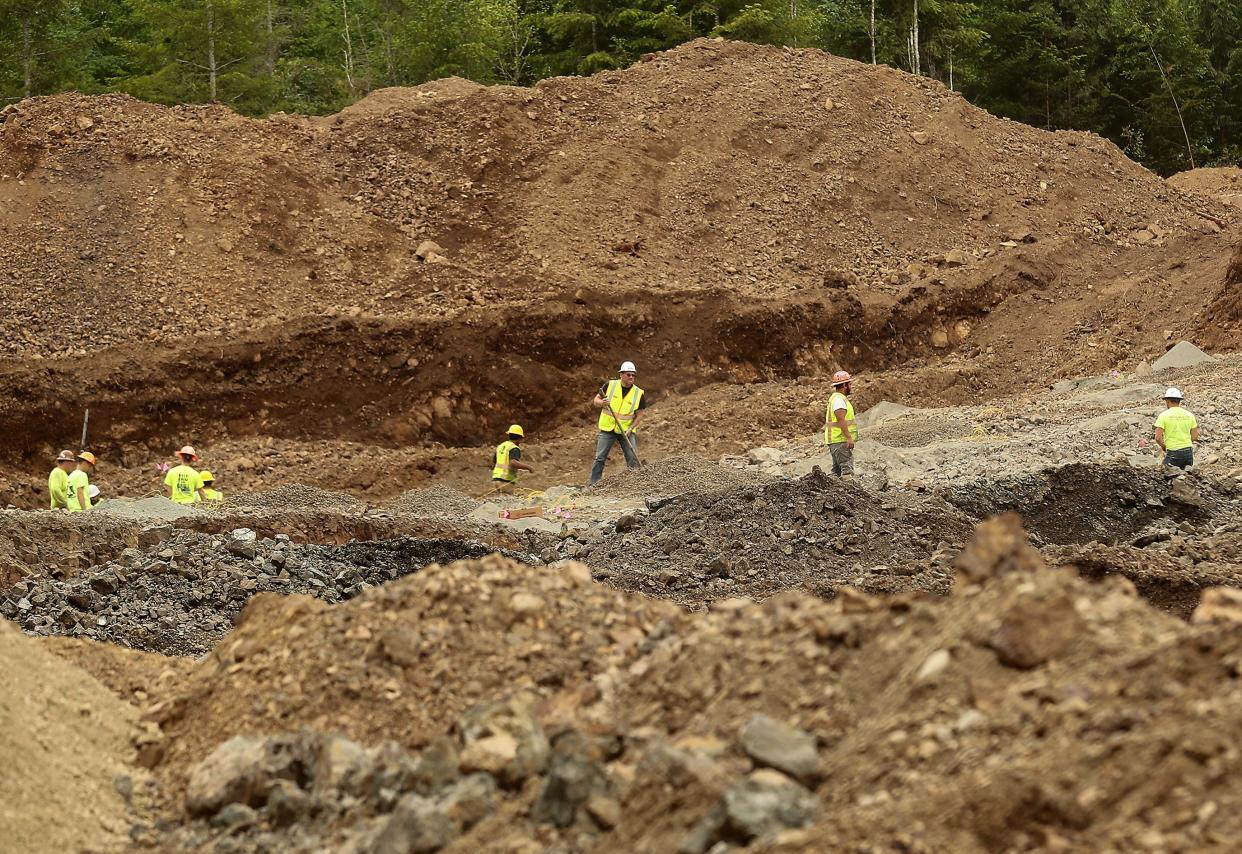 A crew from Chehalis-based McCallum Rock Drilling places explosive powder in the ground at Ueland Tree farm's newest Rock Quarry on Wednesday.