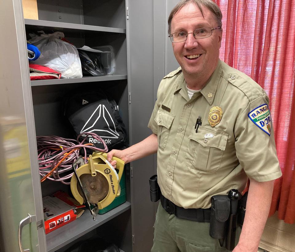 Bryan Hogan, Presque Isle State Park ranger supervisor, shows a circular saw that was found at the park in 2023. The item has yet to be claimed.