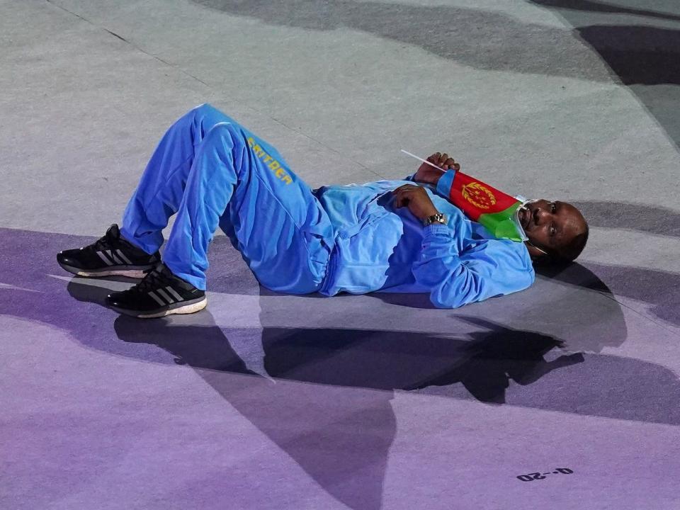 An Eritrean Olympian laid down on the ground during the marathon Olympic parade of nations