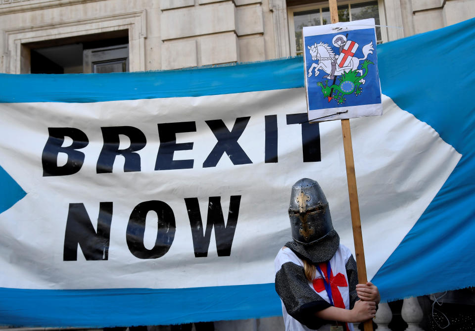 A pro-Brexit supporter holds a placard outside Cabinet Office in London, Britain August 29, 2019. REUTERS/Toby Melville