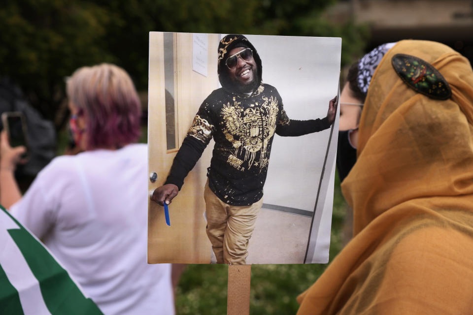 A protester holds Marcus Smith's picture during a demonstration outside City Hall in Greensboro, N.C. (Travis Dove / for The Marshall Project)