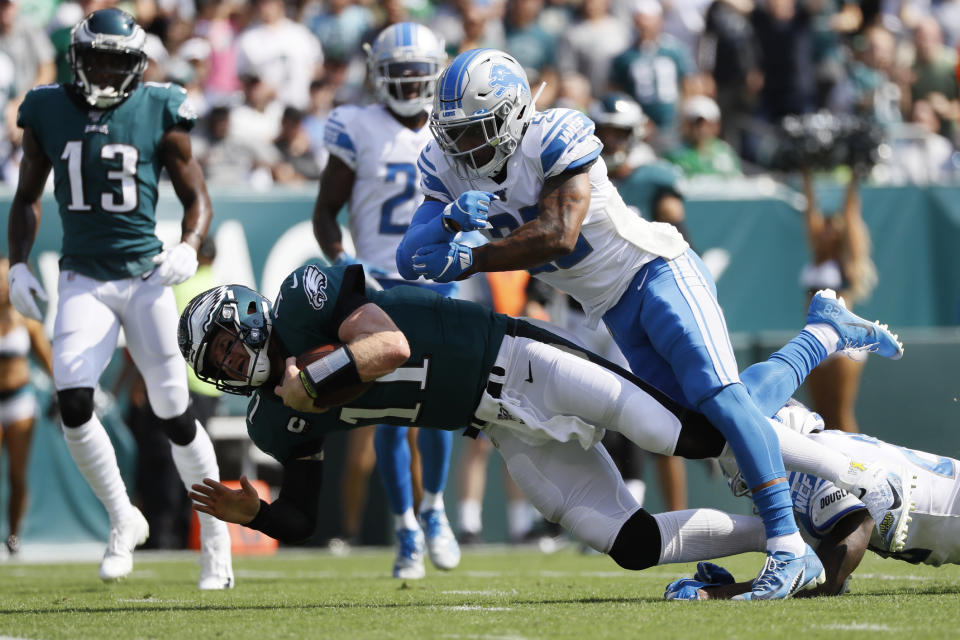 Philadelphia Eagles' Carson Wentz, left, is tackled by Detroit Lions' Quandre Diggs during the first half of an NFL football game, Sunday, Sept. 22, 2019, in Philadelphia. (AP Photo/Michael Perez)