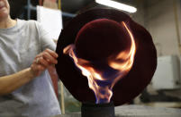 A woman works on a hat in Borsalino's hat factory, in Spinetta Marengo, near Alessandria, Italy, Thursday, Jan. 17, 2019. If the traditional Italian hat-maker Borsalino was once synonymous with the fedora, its new private equity owners want to imbue the brand with cachet that extends to couture, sportswear and streetwear for women and Millennials -- without alienating its classic customers and the silhouette that helped shape the rough-and-tumble images of Robert Redford, Frank Sinatra and, perhaps no one more than, Humphrey Bogart. (AP Photo/Antonio Calanni)