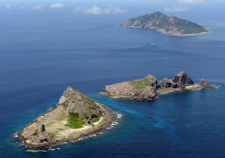 FILE PHOTO - A group of disputed islands, Uotsuri island (top), Minamikojima (bottom) and Kitakojima, known as Senkaku in Japan and Diaoyu in China is seen in the East China Sea, in this photo taken by Kyodo September 2012. Mandatory credit. REUTERS/Kyodo/File Photo