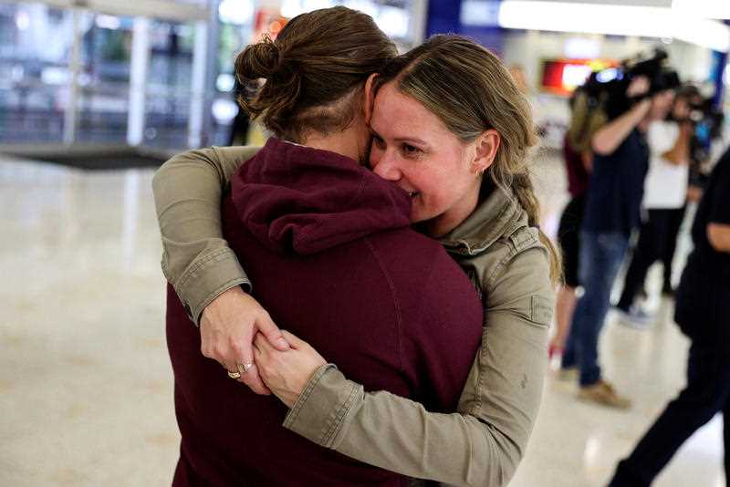 Adam Draper and his partner Stacey Brown hug as she arrives from New Zealand after the Trans-Tasman travel bubble in 2020.