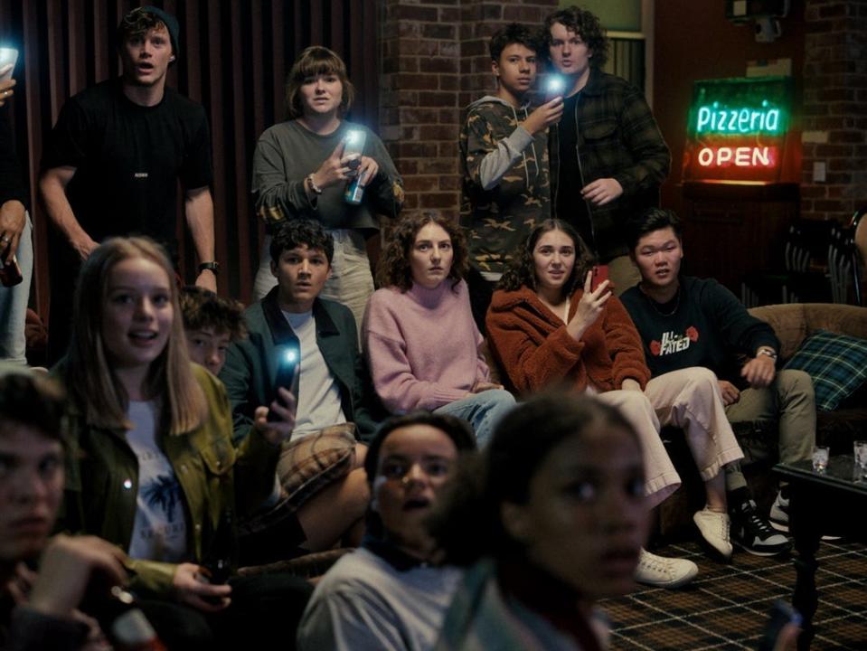 A group of teenagers watch the possession in "Talk to Me."