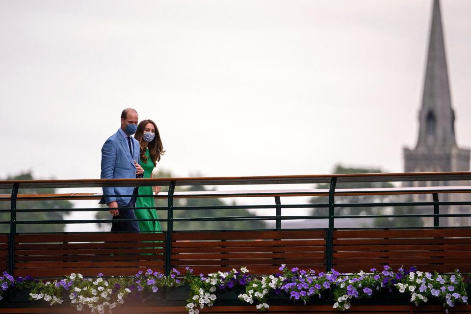 Britain's Catherine, Duchess of Cambridge, and Prince William, Duke of Cambridge, walk across the bridge over St Mary's Walk