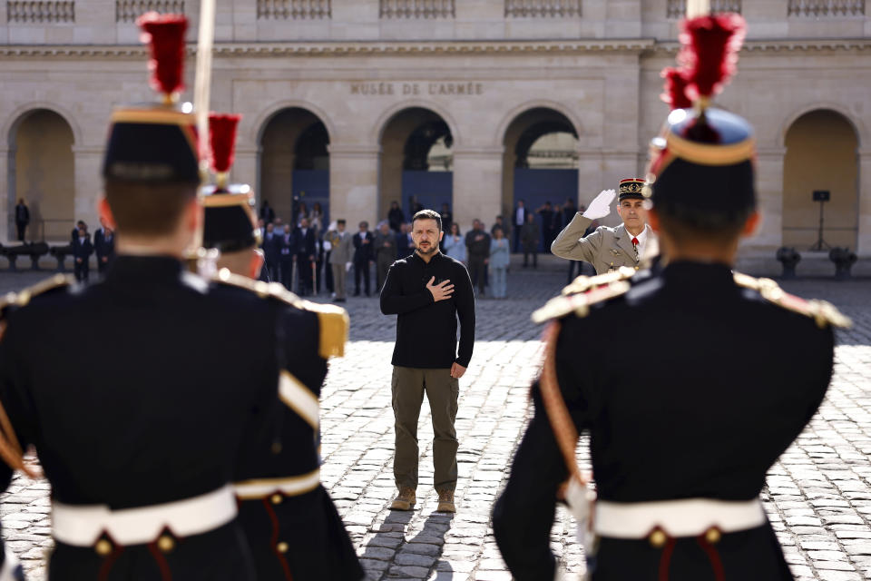 Ukrainian President Volodymyr Zelenskyy listens to the Ukrainian national anthem at the Invalides monument during a military honor ceremony, Friday, June 7, 2024 in Paris. ( Sameer Al-Doumy, Pool via AP)