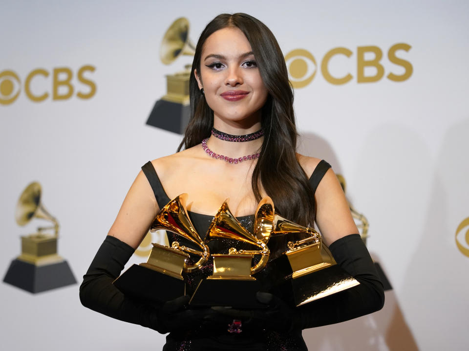 Olivia Rodrigo, winner of the awards for best pop vocal album for "Sour," best new artist and best pop solo performance for "drivers license," poses in the press room at the 64th Annual Grammy Awards at the MGM Grand Garden Arena on Sunday, April 3, 2022, in Las Vegas. (AP Photo/John Locher)